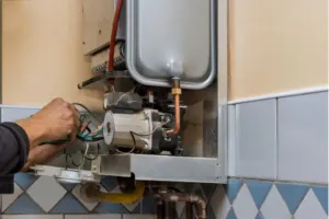 An HVAC expert splices wires together for a furnace installation.